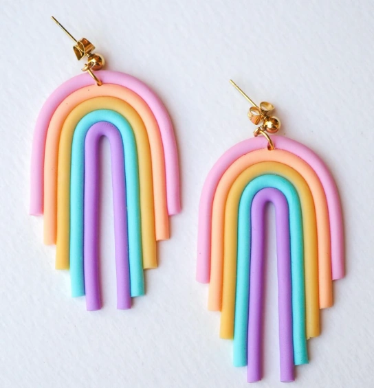 Vibrant clay earrings featuring layered rainbow arcs in pink, blue, purple, and orange, accented with gold hardware.